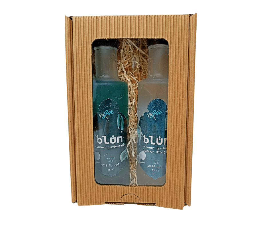 Two 350ml Blün Gin bottles in a rustic brown cardboard gift box with shredded paper filler.