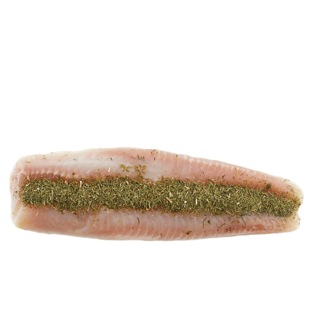 Light pink fish filet seasoned with a generous strip of green herbs on top.